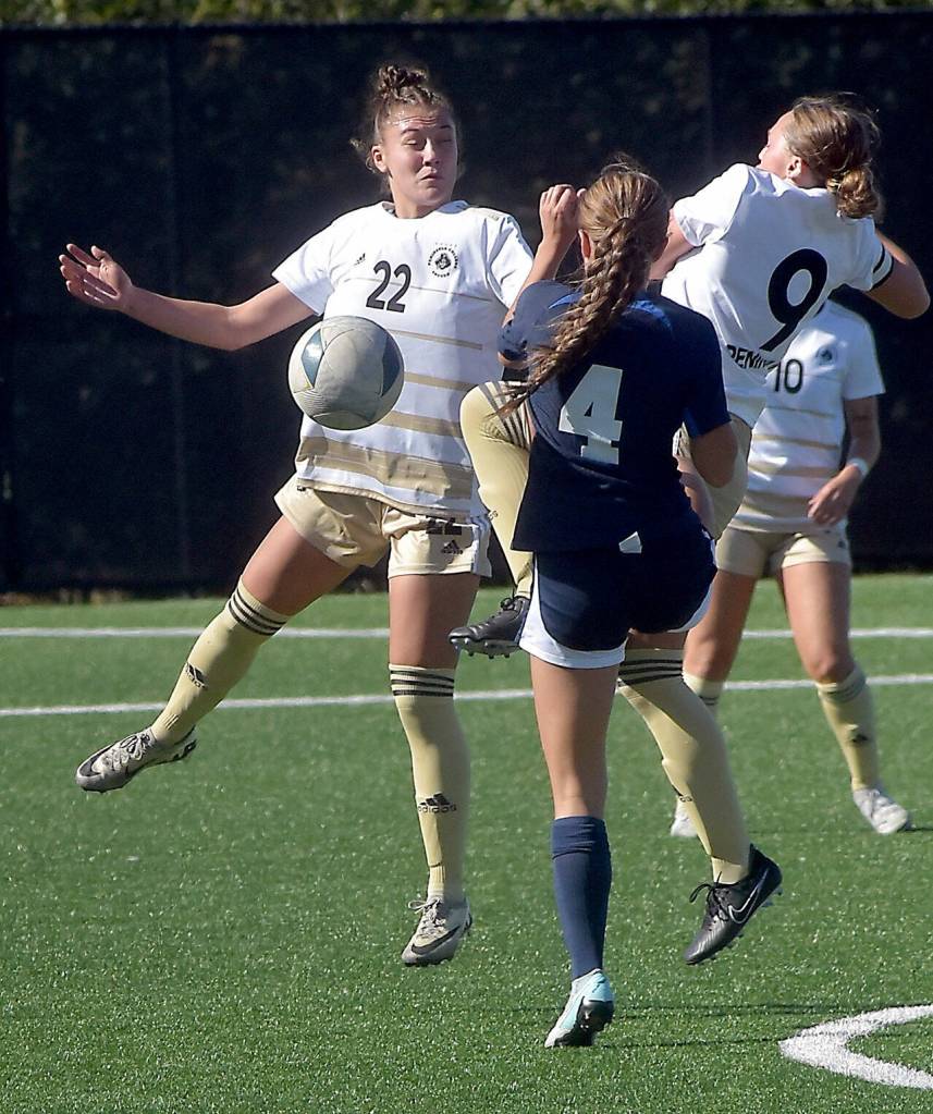 KEITH THORPE/PENINSULA DAILY NEWS Peninsulas Paige Johnson, left, defends the ball as teammate Evee Stoddard provides a block against Bellevues Malia Brown on Wednesday at Peninsula College.