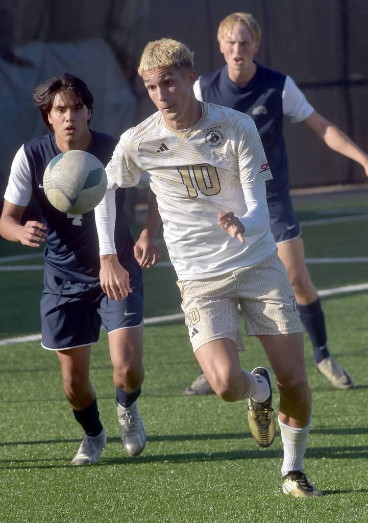 KEITH THORPE/PENINSULA DAILY NEWS
Peninsulas Nil Grau, front, chases a loose ball pursued by Bellevues Patrick Gloria, left, and Beckett Heynen, rear, during Wednesdays match at Peninsula College.