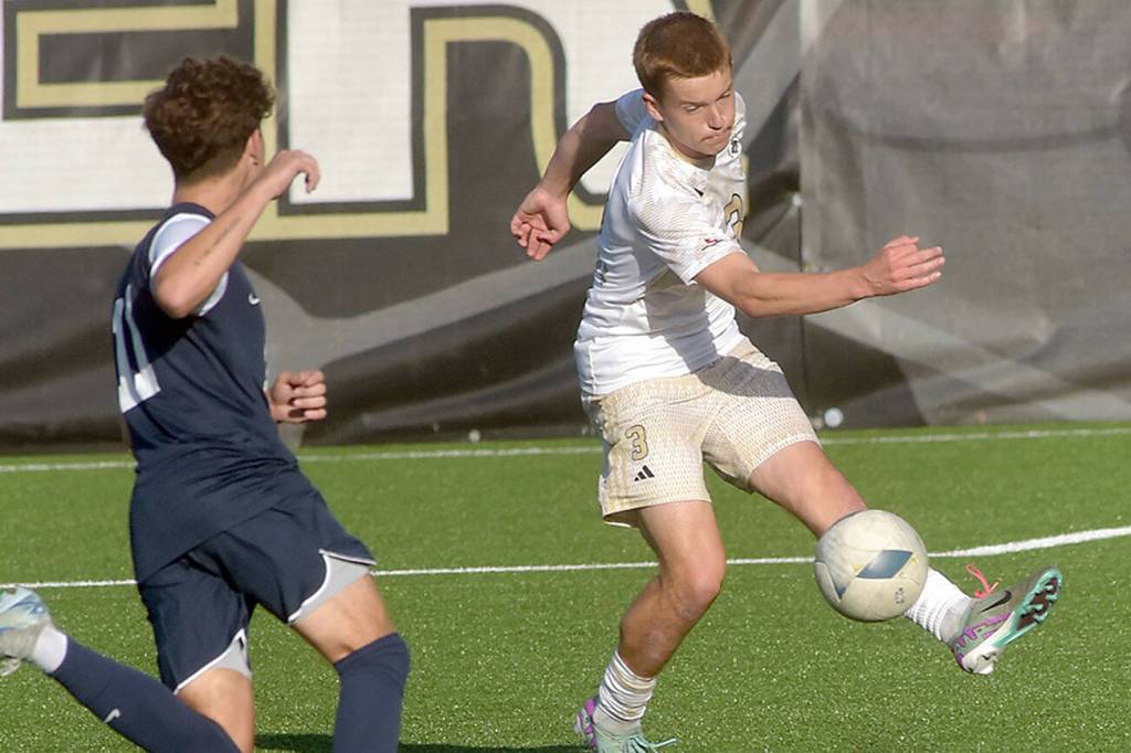 KEITH THORPE/PENINSULA DAILY NEWS
Peninsula's Caleb Rollo, right, passes around the defense of Bellevue's Derek Johnson on Wednesday at Wally Sigmar Field in Port Angeles.