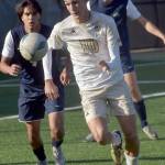 KEITH THORPE/PENINSULA DAILY NEWS Peninsulas Nil Grau, front, chases a loose ball pursued by Bellevues Patrick Gloria, left, and Beckett Heynen, rear, during Wednesdays match at Peninsula College.
