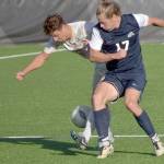 KEITH THORPE/PENINSULA DAILY NEWS Peninsulas Konrad Muller, left battles for the ball with Bellevues Kel Isar on Wednesday in Port Angeles.