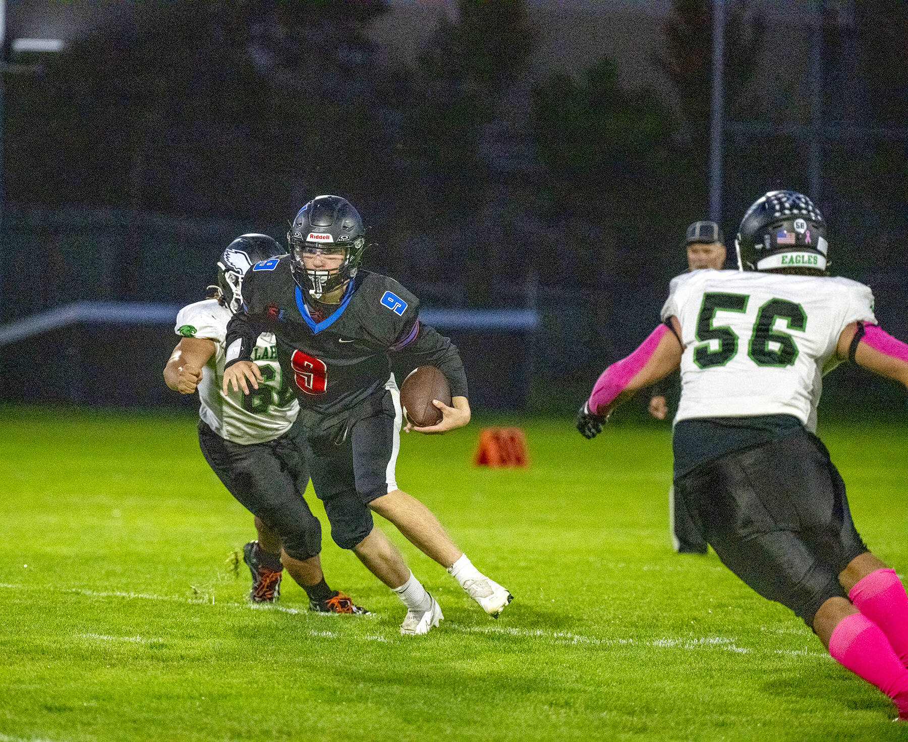 Steve Mullensky/for Peninsula Daily News
Rivals quarterback Silas Morford spots a hole and runs for yardage in a Nisqually League game played against the Klahowya Eagles on Friday night at Memorial Field in Port Townsend.