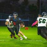 Steve Mullensky/for Peninsula Daily News Rivals quarterback Silas Morford spots a hole and runs for yardage in a Nisqually League game played against the Klahowya Eagles on Friday night at Memorial Field in Port Townsend.