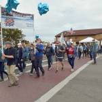 Participants in the Womens March for Humanity cross Sequim Avenue at Washington Street in downtown Sequim on Saturday, part of a rally for U.S. presidential candidate Kamala Harris and running mate Tim Walz. The group of about 200 participants marched from Centennial Place Park to Fifth Avenue and back. (Keith Thorpe/Peninsula Daily News)