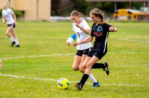 East Jefferson midfielder Olivia McClemans beats Bush's Kate Van Nimwegen to the ball in a nonleague game Saturday in Chimacum. (Steve Mullensky/for Peninsula Daily News)