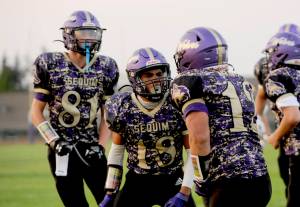 Sequim Wolves, from left, Ethan Melnick, Malachi Hampton and Liam Wiker take on North Kitsap in Poulsbo in a rare Thursday game. (Michael Dashiell/Olympic Peninsula News Group)
