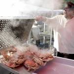 Mario Casarez of U.S. Food pours out a batch of freshly-boiled crabs in preparation for Fridays opening day of the Dungeness Crab Festival. The three-day festival celebrates a wide variety of seafood available for purchase, as well as music, merchandise vendors and other activities centered around the Red Lion Hotel parking lot and other nearby venues. (KEITH THORPE/PENINSULA DAILY NEWS)