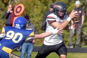 Neah Bay running back Jodell Wimberly evades the tackle of Crescents Logan Simons during Saturdays game in Joyce. (Keith Thorpe/Peninsula Daily News)