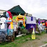 Lori Bernstein, left, and Lindy Brooking, both from Port Townsend, pause from their morning walk to look at the Halloween display set up by the Point Hudson RV Park host. (Steve Mullensky/for Peninsula Daily News)