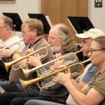 From left, Jim Bradbury, Terry Fogerson, Michael Hornbaum, Doug Brundage and Nancy McPherson, the trumpet section of the Sequim City Band, at a rehearsal. (Mark Wick/Sequim City Band)