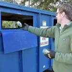 Beeler Van Orman of Port Angeles tosses a glass bottle into a recycling bin on Thursday at the Regional Transfer Station in Port Angeles. (Keith Thorpe/Peninsula Daily News)