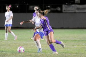 Sequims Ruby Moxley-Horgan, right, jockeys for position during the Wolves 5-0 win over Olympic at home on Thursday. (Matthew Nash/Olympic Peninsula News Group)