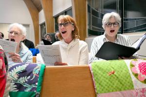 RainShadow Chorale singers Linda Bach, Lisa Hoffman and Jane Hutcheson, all of Port Townsend, rehearse for All Night VIgil. (Karl Perry/RainShadow Chorale)