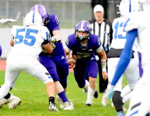 Sequims Zeke Schmadeke looks for room to run against Olympic on Saturday. The Wolves moved the ball, but three fumbles cost them dearly in a 28-7 loss. (Matthew Nash/Olympic Peninsula News Group)