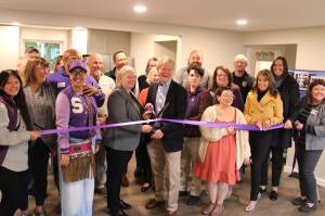 Wendy Sisk, CEO for Peninsula Behavioral Health, and Clallam County commissioner Randy Johnson cut a ribbon with the Sequim-Dungeness Valley Chamber of Commerce on Oct. 16 for PBHs first transitional house in Sequim. County funds helped pay for the refurbished home for five adults. (Peninsula Behavioral Health)