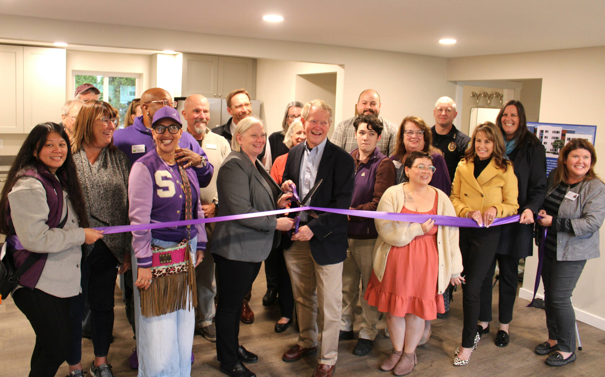 Wendy Sisk, CEO for Peninsula Behavioral Health, and Clallam County commissioner Randy Johnson cut a ribbon with the Sequim-Dungeness Valley Chamber of Commerce on Oct. 16 for PBHs first transitional house in Sequim. County funds helped pay for the refurbished home for five adults. (Peninsula Behavioral Health)