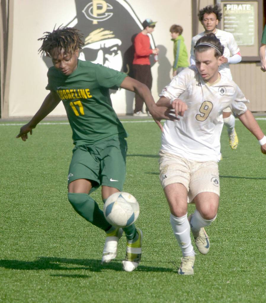 KEITH THORPE/PENINSULA DAILY NEWS Shorelines William Mockey, left, and Peninsulas Pau Vivas battle for the ball on Saturday at Wally Sigmar Field.
