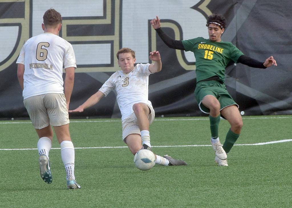 KEITH THORPE/PENINSULA DAILY NEWS Peninsulas Caleb Rolo, center, makes a sliding tackle on Shorelines Hamza Askour as teammate Konrad Muller looks on during Saturdays match in Port Angeles.
KEITH THORPE/PENINSULA DAILY NEWS Peninsulas Caleb Rolo, center, makes a sliding tackle on Shorelines Hamza Askour as teammate Konrad Muller looks on during Saturdays match in Port Angeles.