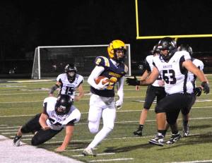 Forks Noah Foster runs down the sideline against Raymond-South Bend at Spartan Stadium on Friday night. Forks won 35-8. (Lonnie Archibald/for Peninsula Daily News)