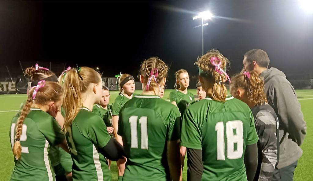Coach Dan Horton talks to his players before they take on Kingston for third place in the Olympic League on Tuesday night. Kingston won 3-0 but the Roughriders will still move on to postseason. (Pierre LaBossiere/Peninsula Daily News)