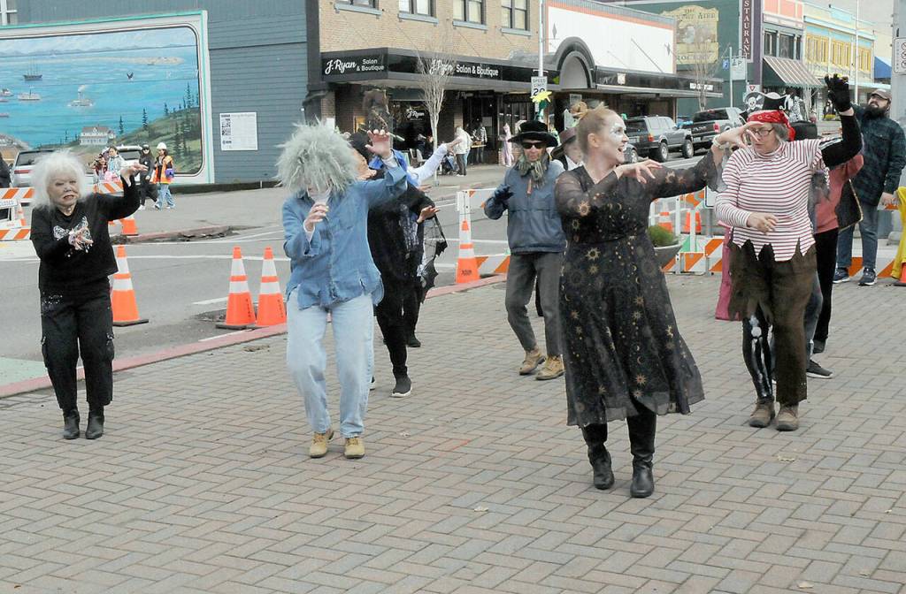Members of the Port Angeles Senior Center perform the Thriller dance to the music of Michael Jackson at the plaza of the Conrad Dyar Memorial Fountain as part of Halloween festivities in downtown Port Angeles. (Keith Thorpe/Peninsula Daily News)
