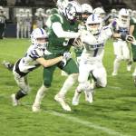 Port Angeles Ricky Peterson battles Olympic tacklers in Friday nights season finale at Port Angeles Civic Field. Peterson had a 20-yard touchdown run in the game. (Dave Logan/for Peninsula Daily News)