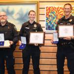 Sequim Police officers, from left, Devin McBride, Ella Mildon and Chris Moon receive 2024 Lifesaving Awards on Oct. 28 for their medical response to help a man after he was hit by a truck on U.S. Highway 101. (Barbara Hanna)