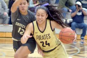 KEITH THORPE/PENINSULA DAILY NEWS Peninsulas Shania Moananu, right, drives past Shorelines Mailana Mattos on Wednesday night in Port Angeles.