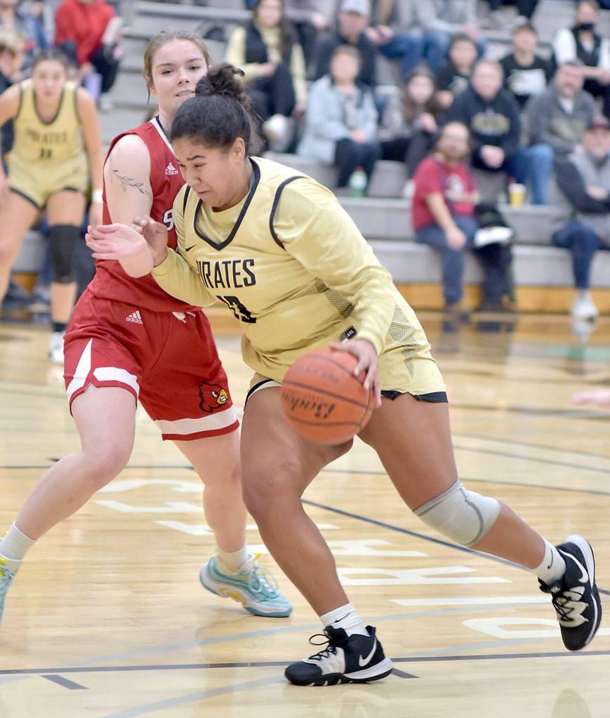 KEITH THORPE/PENINSULA DAILY NEWS Peninsulas Jelissa Julmist, front, pushes her way to the lane past Skagit Valleys Jenae Rhoads on Wednesday evening at Peninsula College.