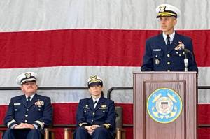 Rear Admiral Charles E. Fosse, right, U.S. Coast Guard District 13 commander, was the guest speaker at the U.S. Coast Guard Station Port Angeles annual Veterans Day celebration on Monday. Chaplain Mike VanProyen, left, and Kelly Higgins, the commanding officer at Coast Guard Air Station Port Angeles, also participated in the ceremony. (Paula Hunt/Peninsula Daily News)