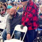 Sutton Beckett, left, assists his neighbor Richard Smelling, 93, stand during the Armed Forces Salute at the Veterans Day ceremony Monday at U.S. Coast Guard Station Port Angeles. Smelling, a Port Angeles native, served in the Air Force during the Korean War. (Paula Hunt/Peninsula Daily News)