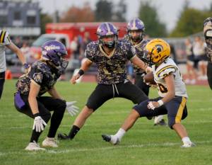 Sequims Zeke Schmadeke, center, gets ready to tackle a Forks runner early this season in Sequim. Schmadeke made the all-Olympic League first team as a defensive back. (Michael Dashiell /Olympic Peninsula News Group)