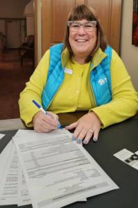 Colleen Robinson, CEO of Habitat for Humanity of Clallam County, signs off on purchasing 7.7 acres at 303 Mill Road in Carlsborg. Part of the $1.93 million purchase was covered by an $854,000 bequest from the late Frances J. Lyon. The property will be called Lyons Landing. (Habitat for Humanity of Clallam County)