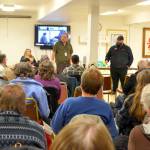 Fire Marshal and floodplain administrator Phil Cecere answers questions with deputy floodplain administrator Greg Ballard on Monday night in Brinnon. (Elijah Sussman/Peninsula Daily News)