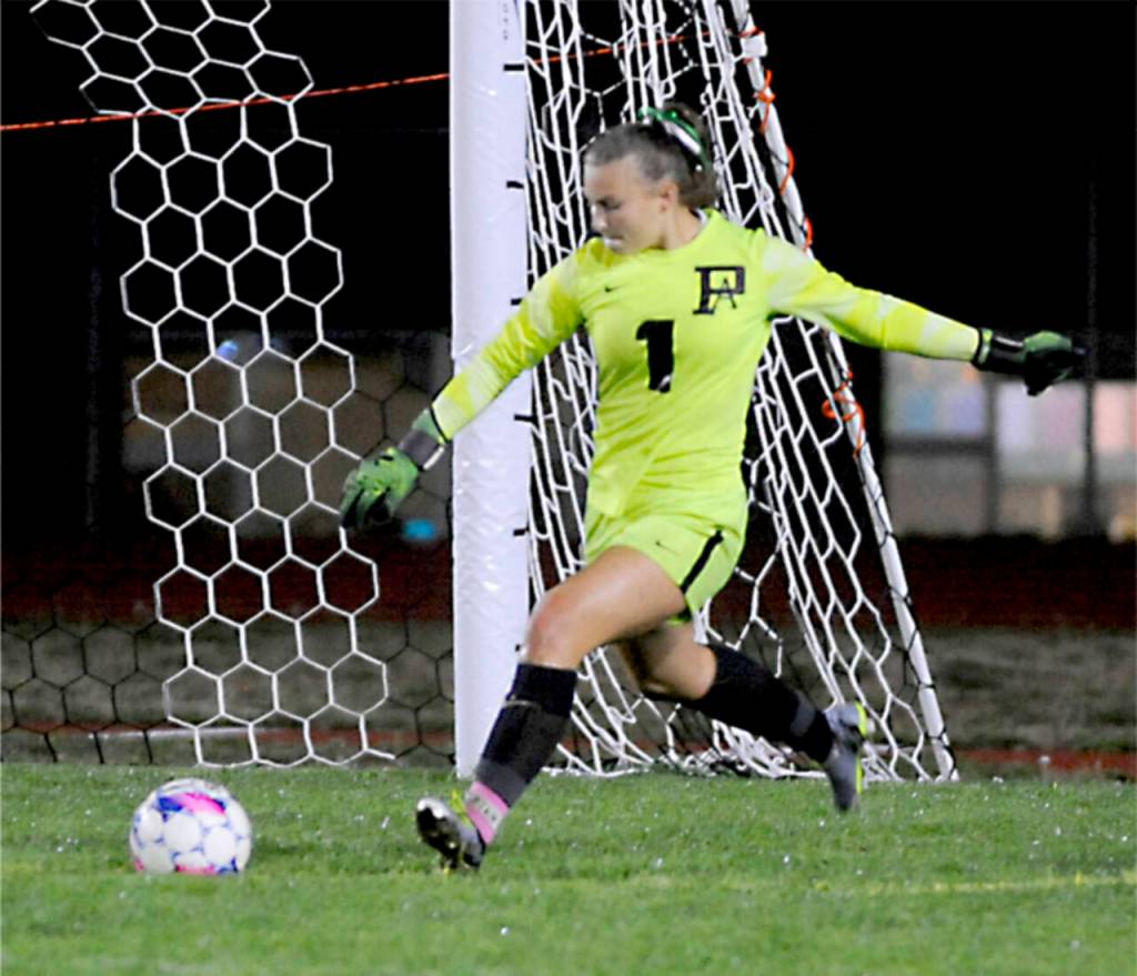 Port Angeles Kennedy Rognlien strikes the ball against Sequim. (Michael Dashiell/Olympic Peninsula News Group)
