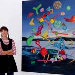 Artist Karen Hackenberg in her Discovery Bay home studio with her painting titled The Floating World. (photo by Craig Wester)