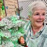 Sherry Phillips, chair of the Festival of Trees design committee, stands next to the tree Twelve Days of Christmas, which she designed personally. (Leah Leach/for Peninsula Daily News)