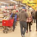 Janet Lucas, left, finds a special purchase of a mail manager at Swains early Friday morning. Black Friday shoppers descended on the Port Angeles store at 8 a.m. There were dozens of early risers who went looking for special bargains on one of the biggest shopping days of the year. (Dave Logan/for Peninsula Daily News)