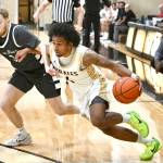 Peninsula College's Patrick Odingo drives against Green River's Maddux Albers on Tuesday in Port Angeles. (Jay Cline/Peninsula College)