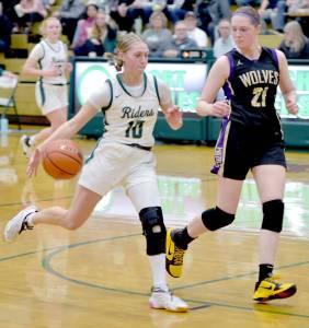 KEITH THORPE/PENINSULA DAILY NEWS Port Angeles Teanna Clark, left, takes to ball to the lane as Sequims Libby Turella follows along on Tuesday in Port Angeles.