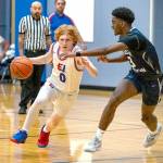 Steve Mullensky/for Peninsula Daily News

East Jefferson's Traycen Brown drives while defended by Cascade Christian's Josiah Gopaul during a 2023-24 contest at Chimacum High School.