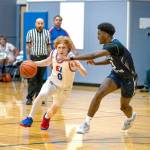 Steve Mullensky/for Peninsula Daily News East Jeffersons Traycen Brown drives while defended by Cascade Christians Josiah Gopaul during a 2023-24 contest at Chimacum High School.