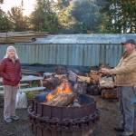 Ann and Steve Johnson talk about some of the stories visitors to the Lazy J Tree Farms Christmas U-Cut have brought them through the years at the fire pit, which is an amenity outside their Christmas barn. (Emily Matthiessen/Olympic Peninsula News Group)