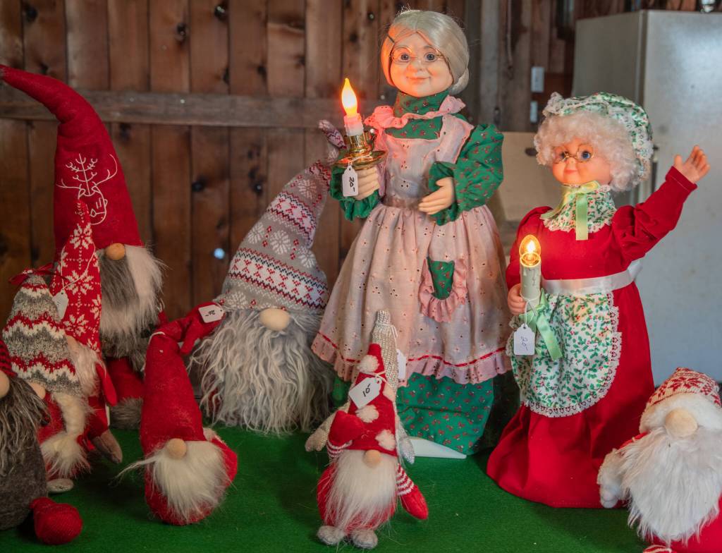 Animatronic Mrs. Clauses surrounded by Tomtens greet customers in the Lazy J Christmas Barn. Every year, a different selection of gently used Christmas items is offered, as well as tree stands and produce and apple cider. (Emily Matthiessen/Olympic Peninsula News Group)