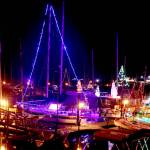 Many colorful Christmas lights that adorn sailboats reflect in the calm waters at Port Angeles Boat Haven. The weather forecast predicts high temperature in the low 50s across the Peninsula this weekend with an increased chance for showers on Saturday and Sunday. (Dave Logan/for Peninsula Daily News)
