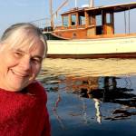 Betsy Davis, the executive director of the Northwest School of Wooden Boatbuilding, with her 1914 wooden boat Glory Be. (Northwest School of Wooden Boatbuilding)