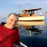 Betsy Davis, the executive director of the Northwest School of Wooden Boatbuilding, with her 1914 wooden boat Glory Be. (Northwest School of Wooden Boatbuilding)