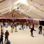 Skaters glide across the Winter Ice Village on Front Street in downtown Port Angeles. The Winter Ice Village, operated by the Port Angeles Chamber of Commerce, is open daily from noon to 9 p.m. through Jan. 5. (Dave Logan/for Peninsula Daily News)