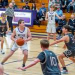 Sequim's Braydan White (21) drives the lane as Ethan Melnick (0) is also in on the play Saturday in Sequim against W.F. West. The Wolves won 59-42. (Emily Matthiessen/Olympic Peninsula News Group)