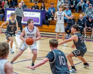 Sequim's Braydan White (21) drives the lane as Ethan Melnick (0) is also in on the play Saturday in Sequim against W.F. West. The Wolves won 59-42. (Emily Matthiessen/Olympic Peninsula News Group)